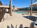Community pool with lounge chairs and mature palm trees at 5020 Indian River Dr # 432, Las Vegas, NV 89103