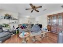 Open living area with ceiling fan, wood floors, and view into the kitchen area at 5083 Village Dr, Las Vegas, NV 89142