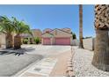 Two-story home with a two-car garage, palm trees, and desert landscaping for an appealing curb presence at 5907 Zawawi Ct, Las Vegas, NV 89110