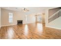 Spacious living room showcasing wood floors, fireplace, and staircase to the second level at 5921 Royal Castle Ln, Las Vegas, NV 89130