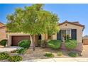 Attractive single-story home featuring a well-manicured front yard with landscaping and a two-car garage at 6808 Mystic Plain Ct, Las Vegas, NV 89149