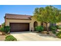 Charming single-story home with a well-manicured front yard, lush landscaping, and a two-car garage at 6808 Mystic Plain Ct, Las Vegas, NV 89149