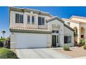 Two-story home featuring a well-manicured lawn and convenient two-car garage at 7813 Falconwing Ave, Las Vegas, NV 89131