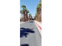 Palm tree lined street leads to various properties and amenities within the community at 9050 W Warm Springs Rd # 1092, Las Vegas, NV 89148