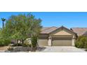 Charming single-story home featuring desert landscaping, a tile roof, and a spacious three-car garage at 9233 Onyx Point Ct, Henderson, NV 89074