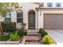 Welcoming front entrance with brick steps, complemented by lush greenery and an arched doorway at , Las Vegas, NV 89166
