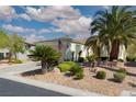 Beautiful single-story home with desert landscaping, mature palm trees and an American flag at 10240 Notte Ave, Las Vegas, NV 89135
