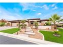Inviting single-story home with manicured lawn and palm trees at 11 Knob Oak Dr, Henderson, NV 89052