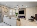 Cozy living room with a modern fireplace, neutral tones, and plantation shutters for natural light at 11402 Ethereal Landing Ave, Las Vegas, NV 89138