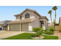 Beautiful two-story home with a well-maintained lawn and a spacious three-car garage at 1325 Baychester Dr, Henderson, NV 89002