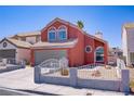 Charming two-story home featuring unique arched windows, a well-maintained yard, and attached two car garage at 1428 Daybreak Dr, Las Vegas, NV 89108