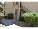 Charming exterior view of the townhome with private entrance and stairs to upper units at 1830 N Buffalo Dr # 1010, Las Vegas, NV 89128