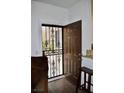 Inviting foyer with decorative security door, wood floors, and natural light at 1830 N Buffalo Dr # 1010, Las Vegas, NV 89128