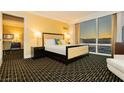 Bedroom featuring modern furnishings, a king bed, large windows with city views, and geometric patterned flooring at 2000 Fashion Show Dr # 5022, Las Vegas, NV 89109