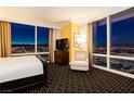 Bedroom with a king bed, chair, floor-to-ceiling windows with a city view at night, and a dresser with a TV at 2000 Fashion Show Dr # 5022, Las Vegas, NV 89109
