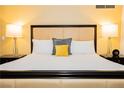 Close-up of king bed with a tufted headboard, white linens, and matching nightstands with lamps at 2000 Fashion Show Dr # 5022, Las Vegas, NV 89109