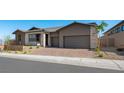 Beautiful single-story home with three-car garage, stone accents, and well-manicured landscaping at 241 Paraggi Bay Dr, Henderson, NV 89011