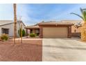 Charming single-story home with desert landscaping, a two-car garage and a tiled roof at 3323 Bay Horse Ct, North Las Vegas, NV 89032