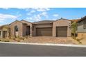 Charming single-story home with a three-car garage and desert landscaping at 346 Tigullio Ave, Henderson, NV 89011