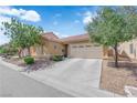 Inviting single-story home with landscaped front yard and a spacious driveway leading to a two-car garage at 3752 Calle De Rio Ave, Las Vegas, NV 89115