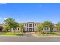 Charming two-story home showcasing lush landscaping and a welcoming entrance at 42 Ravenswood Ave, Las Vegas, NV 89141