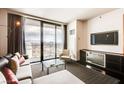 Stylish living room with a comfortable sofa, city view balcony, TV, and sleek furniture, perfect for relaxing at 4381 W Flamingo Rd # 5220, Las Vegas, NV 89103
