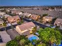 Stunning aerial view of property featuring a backyard pool, tennis court and mature trees at 4737 Barcelona Ridge Ct, Las Vegas, NV 89129