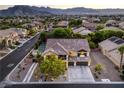 Beautiful aerial view of home in a residential neighborhood with mountain views at 4737 Barcelona Ridge Ct, Las Vegas, NV 89129