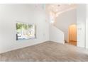 Bright and airy living room with vaulted ceilings, wood-look tile flooring, and abundant natural light at 5340 Santa Fe Heights St, North Las Vegas, NV 89081