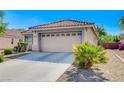 Nice single-story home with a convenient two-car garage, desert landscaping, and a paved driveway at 6656 Arctic Breeze St, North Las Vegas, NV 89084