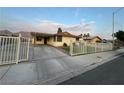 Exterior of the home with driveway, fencing and mountain views at 706 Red Lake Way, Las Vegas, NV 89110