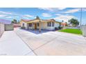 Inviting front exterior with a spacious driveway, covered entrance, and well-maintained landscaping at 706 Red Lake Way, Las Vegas, NV 89110