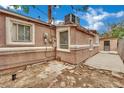 Exterior shot shows the side of the home, with brick pavers, a window A/C unit and secure access at 75 N 27Th St, Las Vegas, NV 89101