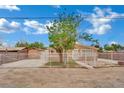 Single-story home with secure fencing, mature trees and easy access to the covered entryway at 75 N 27Th St, Las Vegas, NV 89101