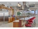 Gourmet kitchen featuring stainless steel appliances, granite countertops, and a breakfast bar at 1223 Casa Palermo Circle Cir, Henderson, NV 89011