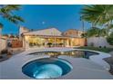 Stunning backyard with a refreshing pool, relaxing hot tub, and well-manicured lawn perfect for outdoor entertaining at 1223 Casa Palermo Circle Cir, Henderson, NV 89011