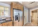 Kitchen with stainless refrigerator, built-in cabinets, and access to the hallway bathroom at 230 E Flamingo Rd # 203, Las Vegas, NV 89169