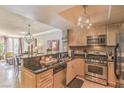 Updated kitchen with stainless steel appliances, granite countertops, and a view into the living area at 230 E Flamingo Rd # 203, Las Vegas, NV 89169