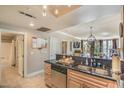 Open concept kitchen with stainless appliances, granite countertops, and convenient access to living spaces at 230 E Flamingo Rd # 203, Las Vegas, NV 89169