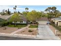 Charming single-story home featuring well-maintained landscaping and a spacious driveway at 2400 Llewellyn Dr, Las Vegas, NV 89102