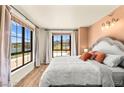 Comfortable bedroom with large windows offering lake views and plenty of natural light at 29 Montelago Blvd # 131, Henderson, NV 89011