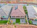 Aerial view of backyard featuring covered patio, artificial turf, privacy wall, and desert landscape at 32 Tatahatso Point St, Henderson, NV 89011