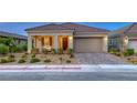 Charming single-story home with a two-car garage, desert landscaping, and a welcoming front porch at 32 Tatahatso Point St, Henderson, NV 89011