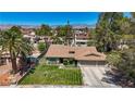Lovely home with palm trees, green lawn, and a two-car garage set against a mountain backdrop at 3361 Iberia St, Las Vegas, NV 89146