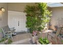 Inviting front entrance featuring double doors, a cozy bench, and lush greenery at 3361 Iberia St, Las Vegas, NV 89146