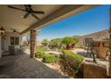 Inviting outdoor patio featuring stone pillars, ceiling fans, and dining seating at 40 Stonemark Dr, Henderson, NV 89052