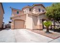 Two-story home with attached garage, desert landscaping and covered porch at 4945 Volcanic Rock Ln, Las Vegas, NV 89122