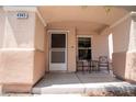Close up on a covered porch with space for a table and chairs by the front door at 4945 Volcanic Rock Ln, Las Vegas, NV 89122