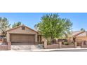 Attractive single-story home featuring desert landscaping, gated entry, and two-car garage at 5453 Palisades Quad Ave, Las Vegas, NV 89122