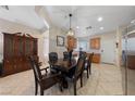 Elegant dining room with a dark wood table and chairs, complemented by a decorative cabinet and neutral tones at 6114 Saddle Horse Ave, Las Vegas, NV 89122